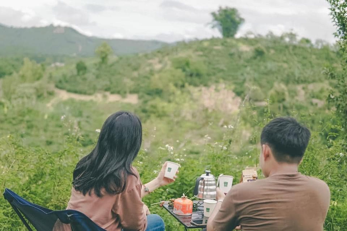 A serene moment of coffee indulgence amidst the tranquility of a mountain forest