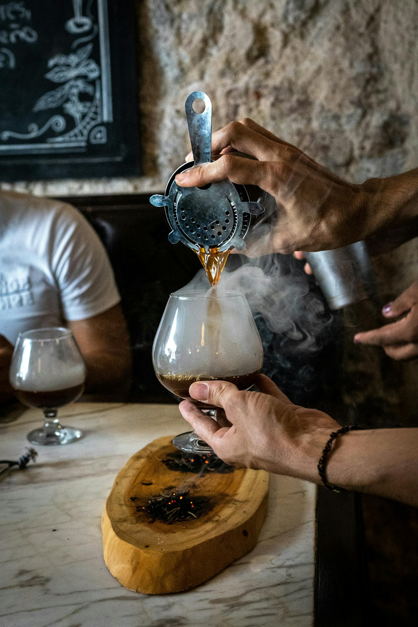 A person pours a type of Coffee Cocktails into a glass